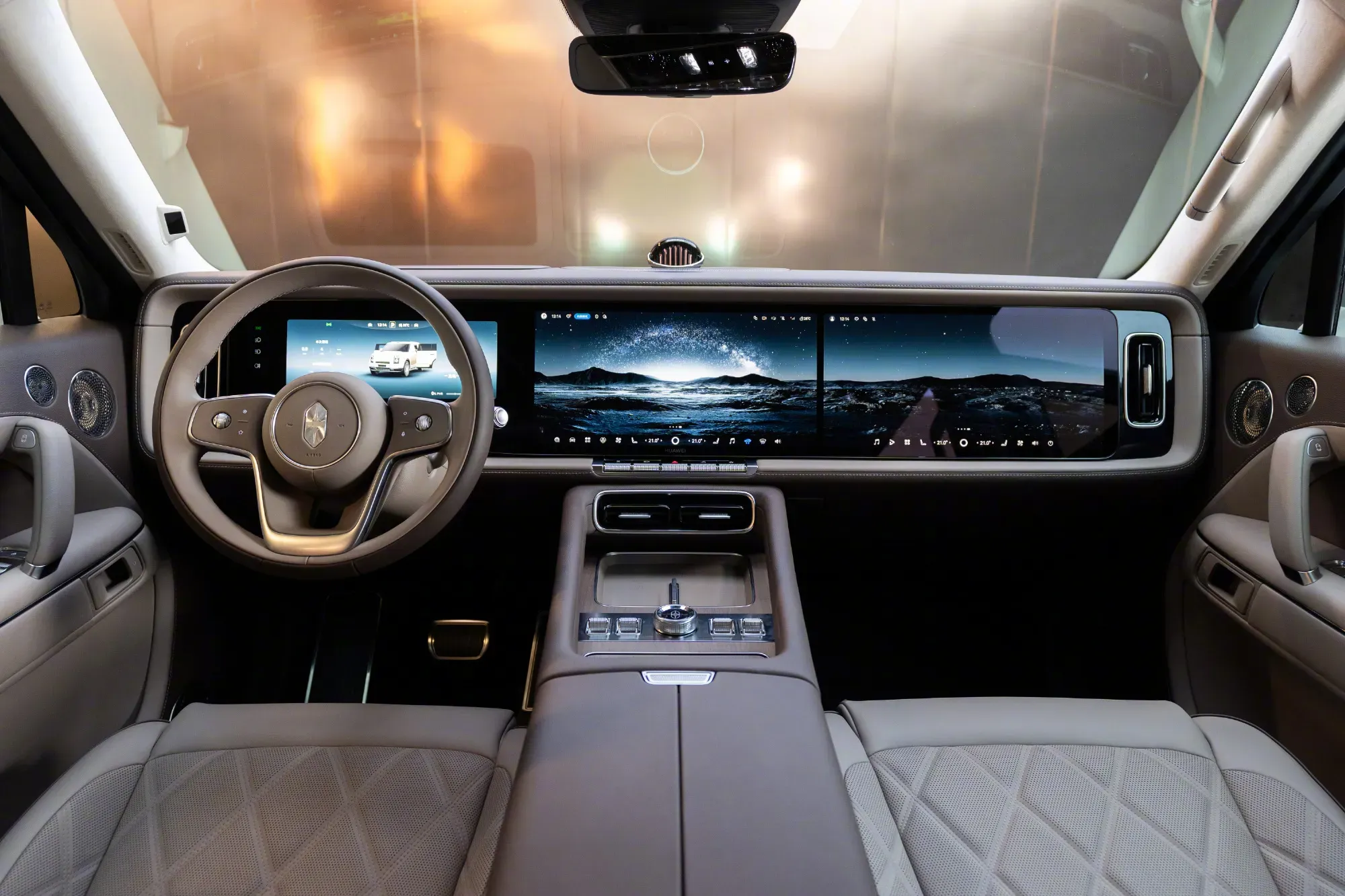 Stelato G9 cockpit view showing the steering wheel and connected tri-screen dashboard display