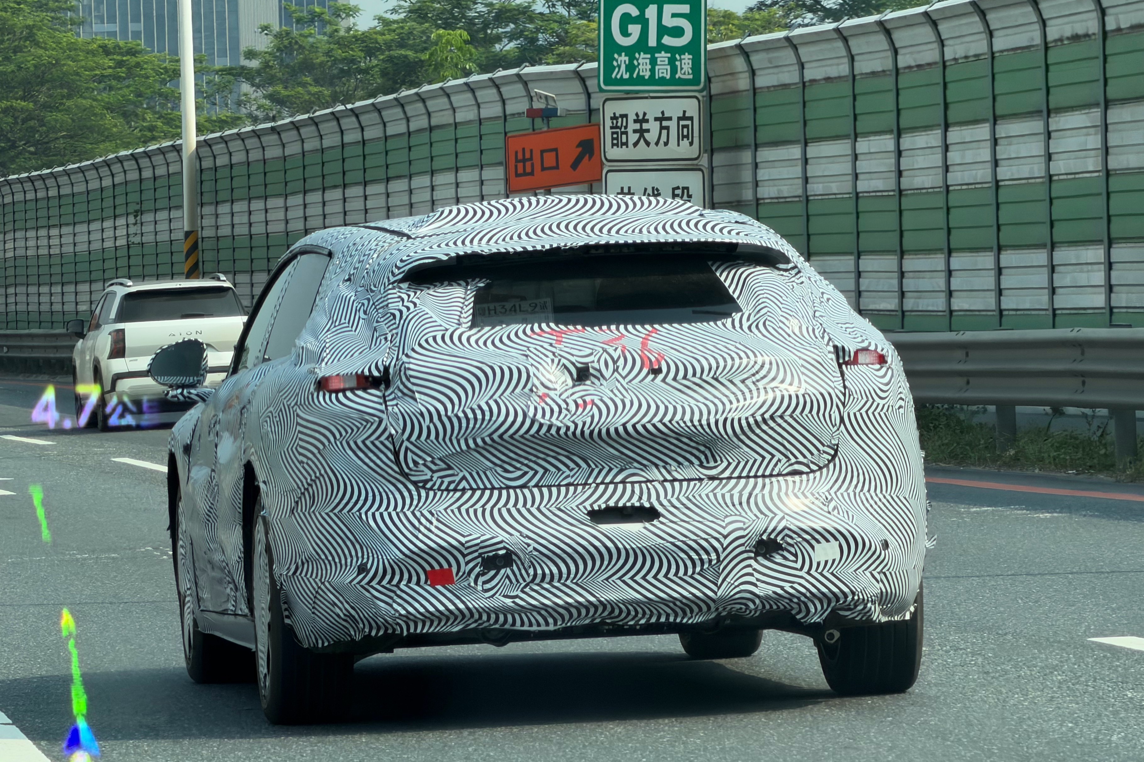 XPeng Mona D11T wagon prototype testing on the G15 Shenhai Expressway in Guangdong, China, rear view, exit sign visible