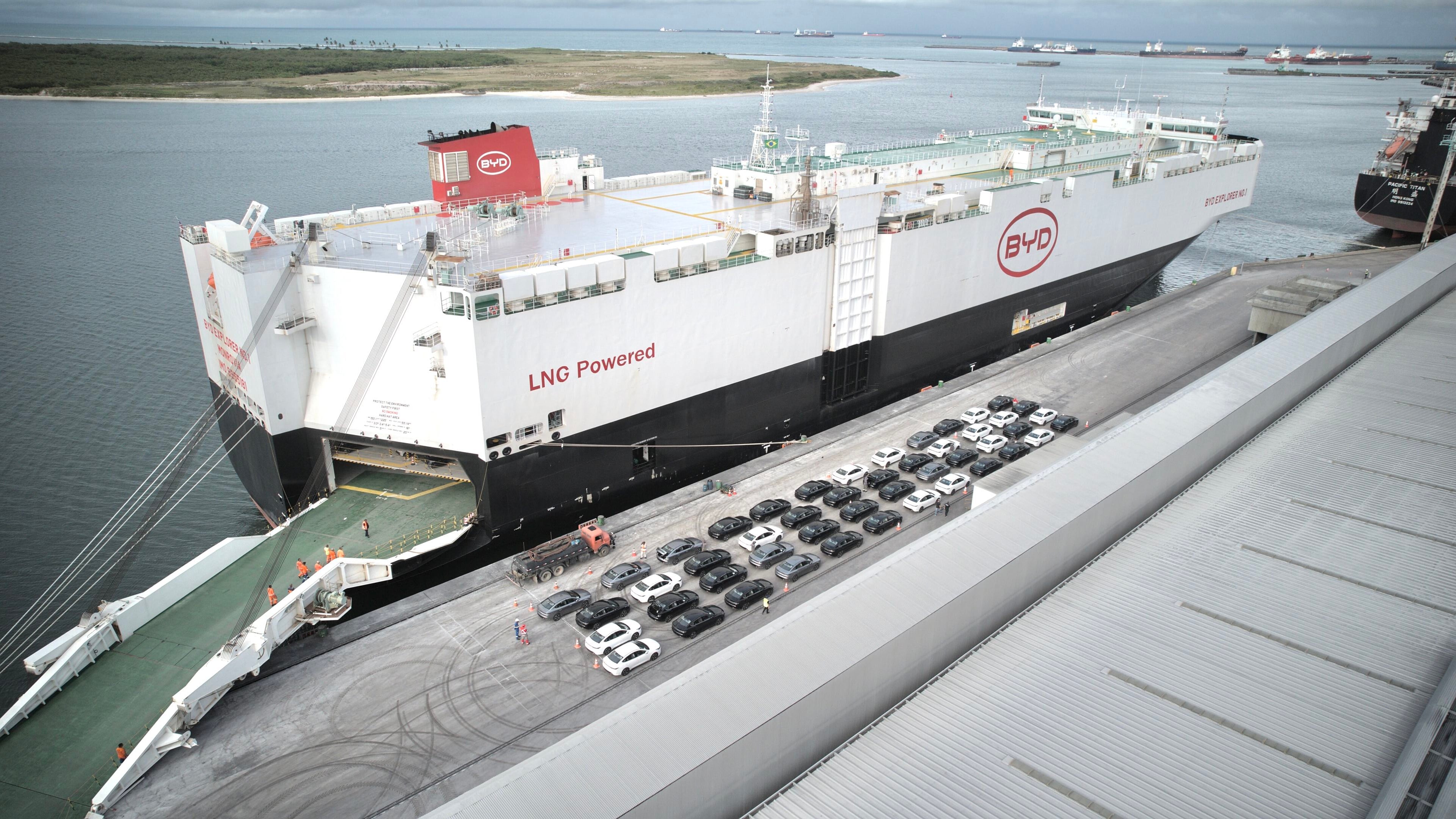 Aerial view of BYD's Explorer No.1 car carrier moored at Brazil's Port of Suape with rows of new cars on the quay