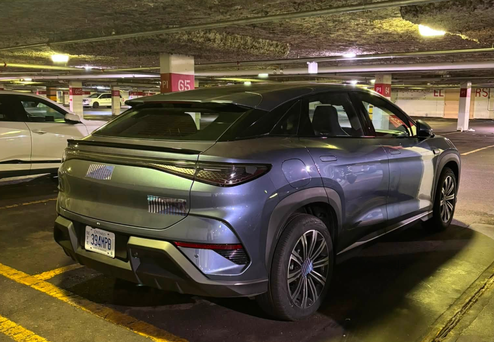 Rear three-quarter view of the BYD Sealion 7 test vehicle in a Markham, Ontario parking garage, with its licence plate visible