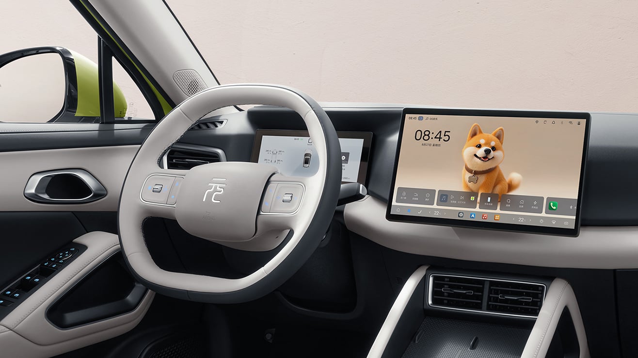 Cockpit of the 2027 BYD Yuan UP Feichi edition with a two-spoke light grey steering wheel and floating central touchscreen