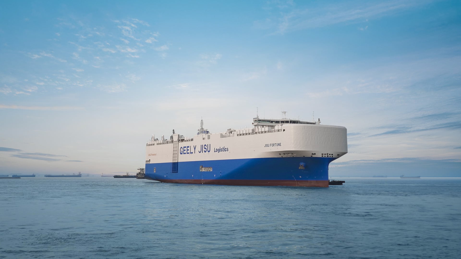 Geely's Jisu Fortune ro-ro car carrier in blue and white Geely Jisu Logistics livery at anchor in open water