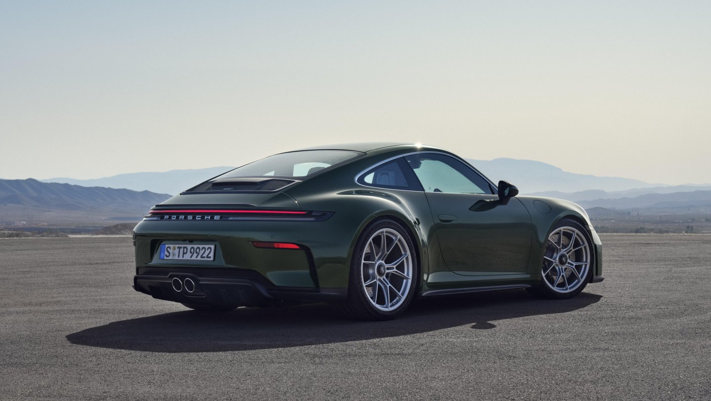 Porsche 911 GT3 Touring parked at a rear three-quarter angle, showing the ducktail spoiler and no rear wing