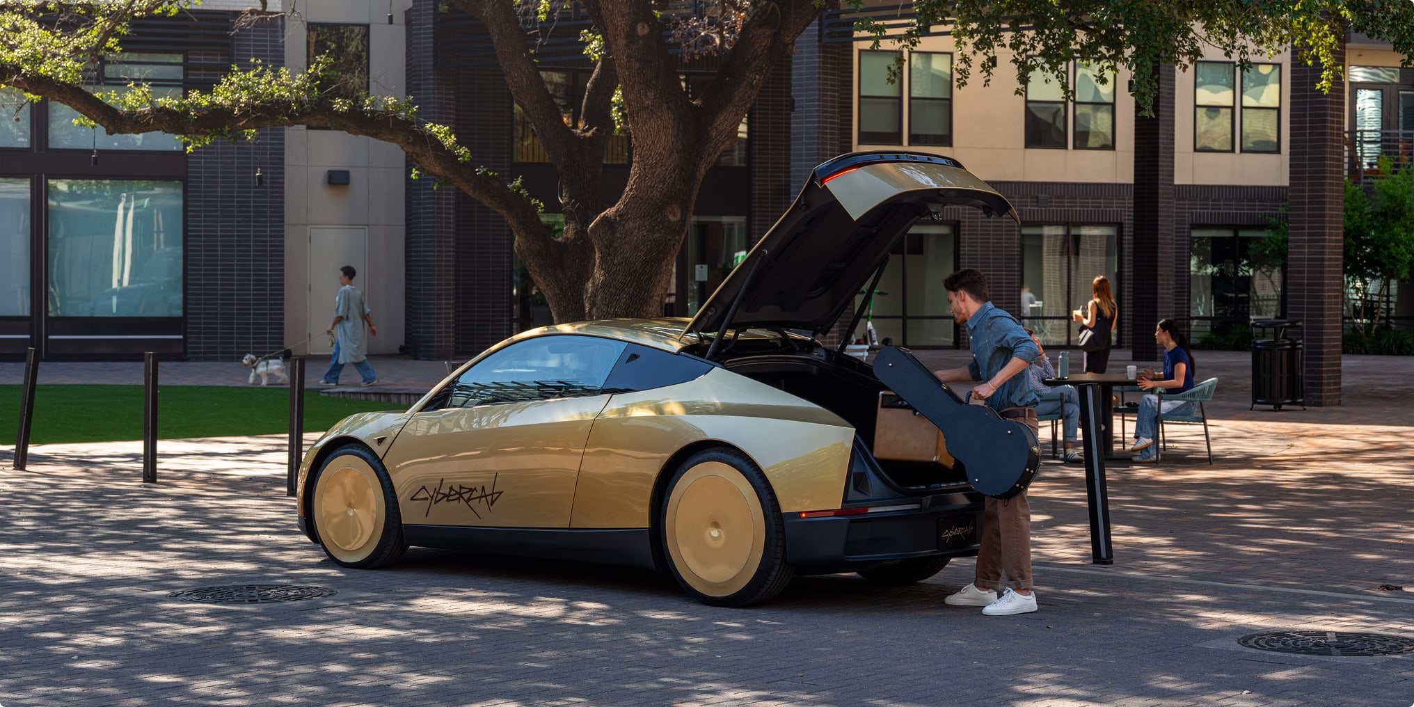 A Tesla Cybercab with its front trunk open as a rider loads a guitar case on a tree-lined plaza.