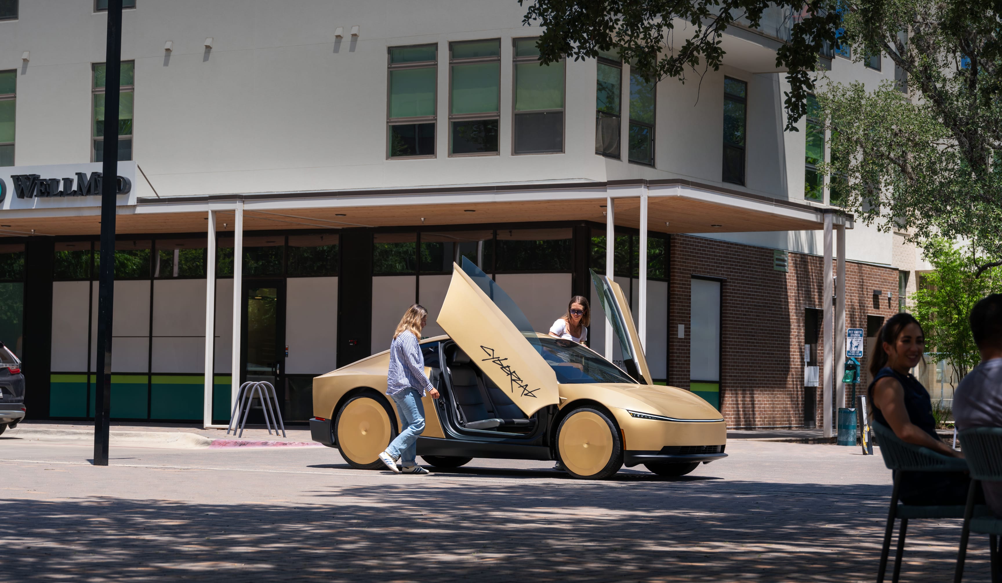 Two riders board a gold Tesla Cybercab through its raised butterfly doors on an Austin street in daylight.