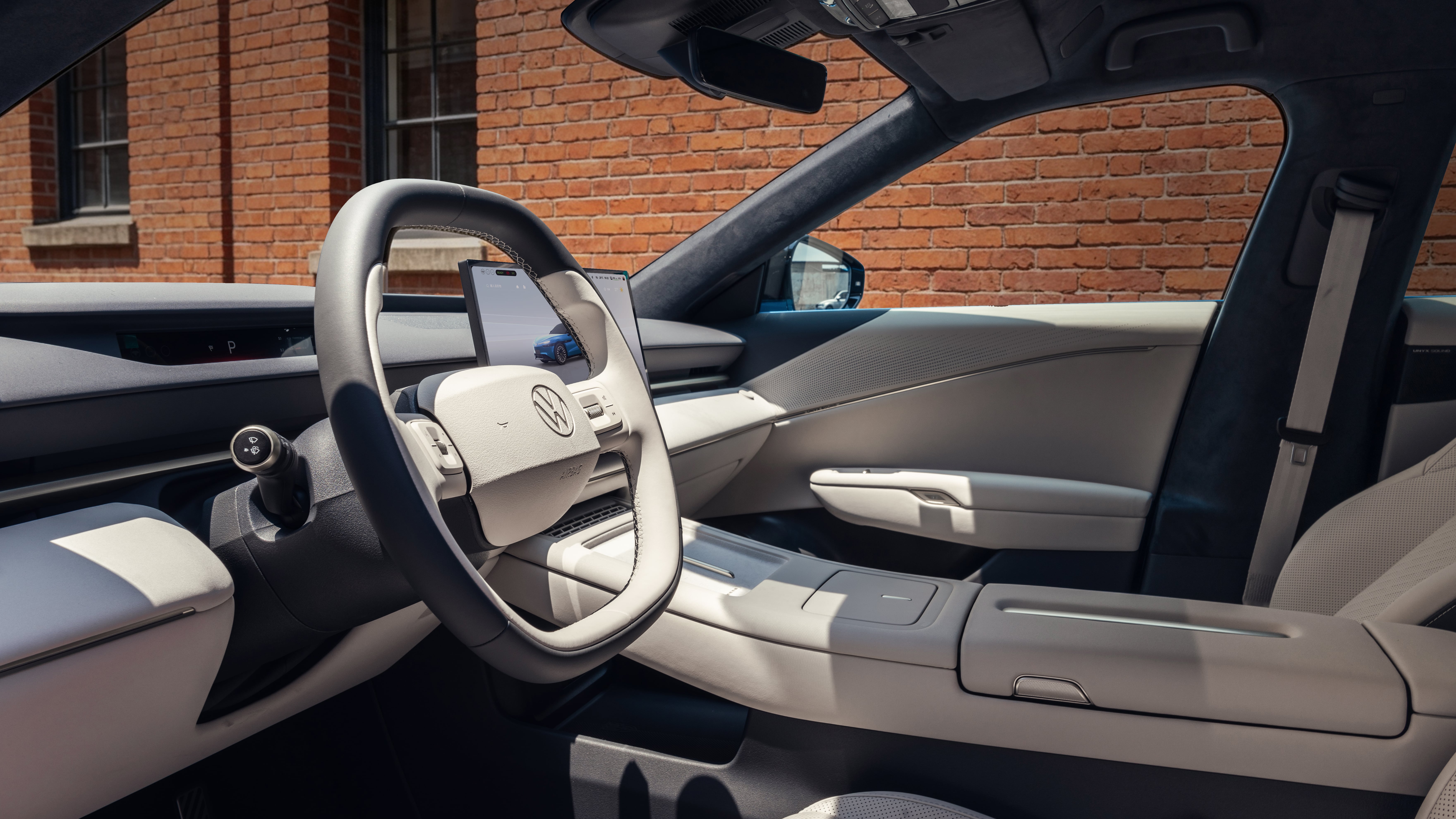 Volkswagen ID. UNYX 09 cabin with light upholstery, squared-off steering wheel and floating central touchscreen