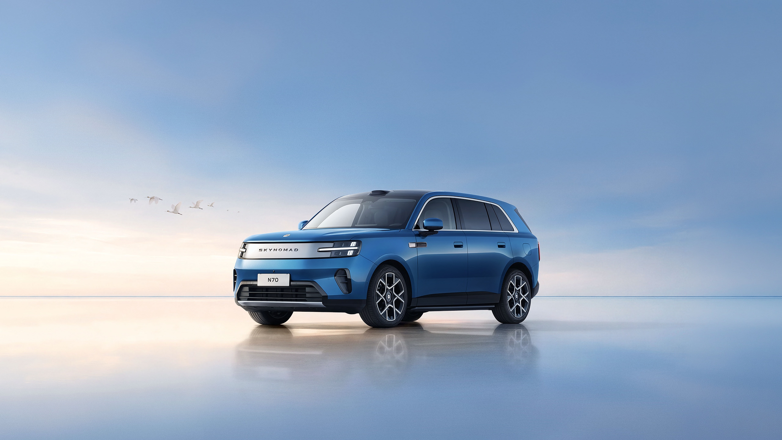 Blue Xiaomi SkyNomad N70 extended-range SUV in front three-quarter view on a reflective surface under a pale sky